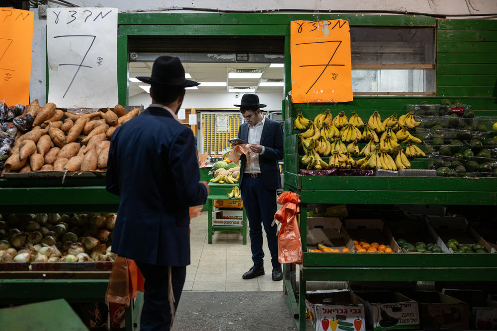 Ultra-Orthodox Jewish men shop for vegetables at a store in Bnei Brak, Israel, on March 21.