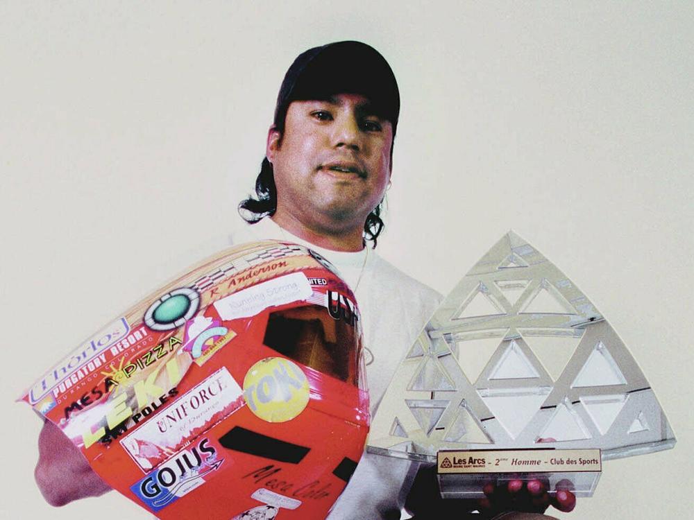 Professional speed skier Ross Anderson holds some of the trophies he won during the 2000-01 winter season. As an indigenous athlete and person of color, Anderson was a trailblazer in professional skiing.