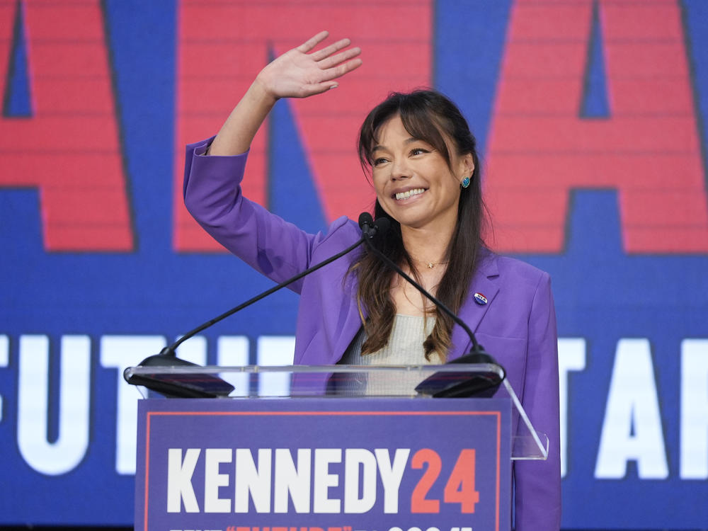 Nicole Shanahan waves from the podium during a campaign event for independent presidential candidate Robert F. Kennedy Jr. Tuesday in Oakland, Calif. The California attorney is now RFK's running mate.
