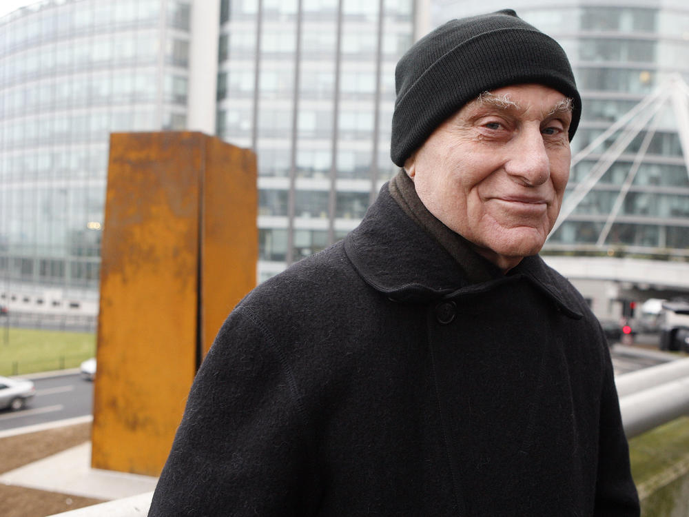 Famed American sculptor Richard Serra poses in front of <em>Slat</em>, a 1984 steel sculpture, after its reinstallation in La Defense, west of Paris, Dec. 15, 2008.
