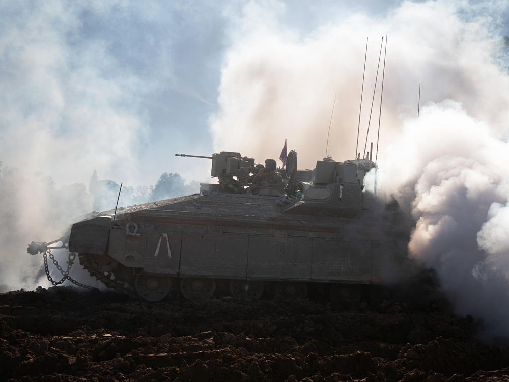 Israeli soldiers unpack their tanks and APC's to load up to trucks, after returning from Gaza on the Gaza border, Israel, Feb. 29.