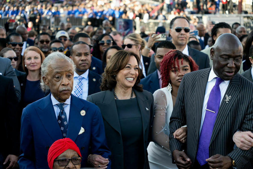 Vice President Kamala Harris links arms with civil rights attorney Ben Crump (right) and the Rev. Al Sharpton (left) in a march across the Edmund Pettus Bridge during a commemoration of the 59th anniversary of Bloody Sunday in Selma, Ala., on March 3.