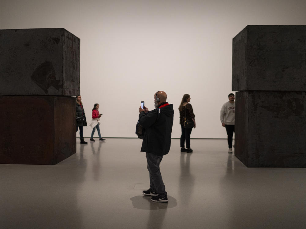 Visitors to the Museum of Modern Art view Richard Serra