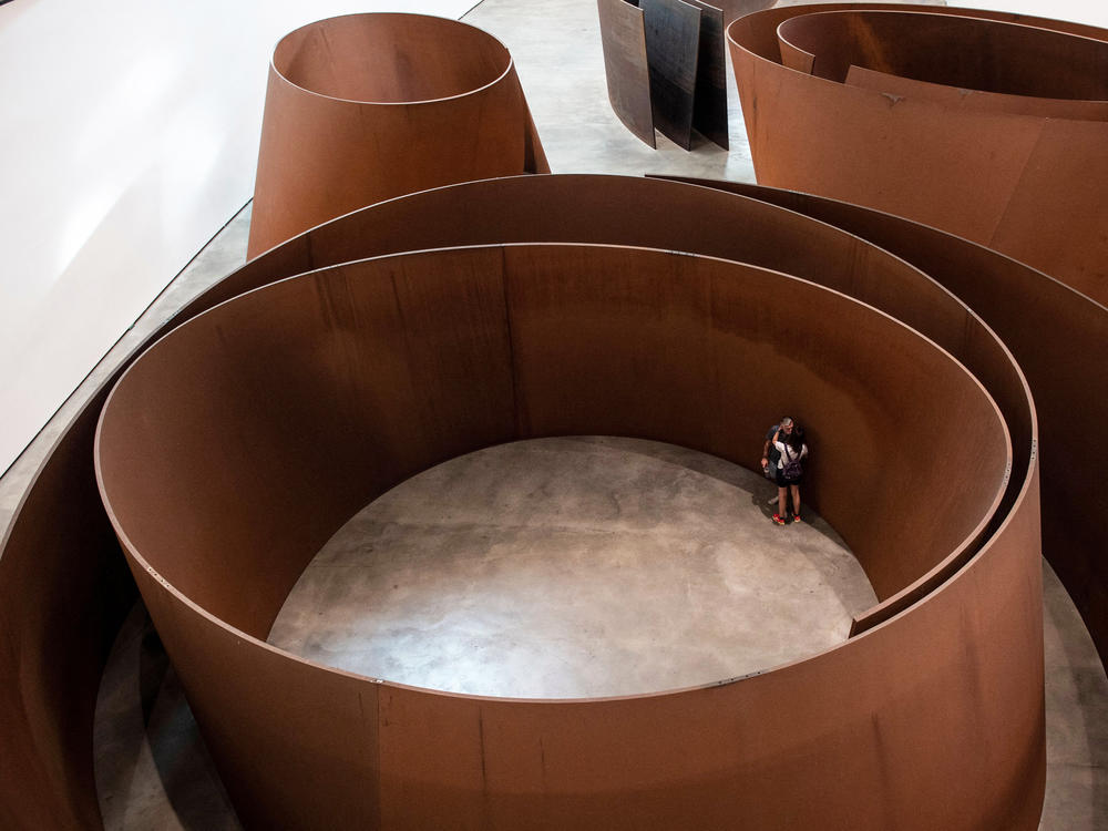 Visitors look at the artwork 