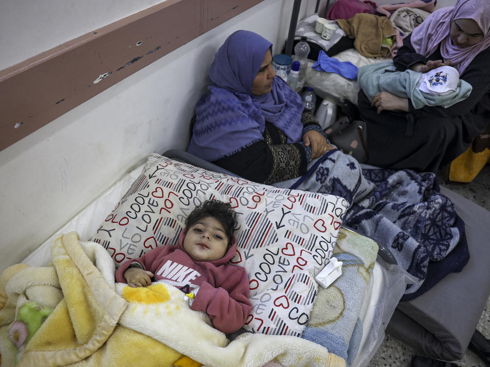 Palestinian women and infants receive medical care at a clinic in Rafah, in the southern Gaza Strip, on Feb. 29.
