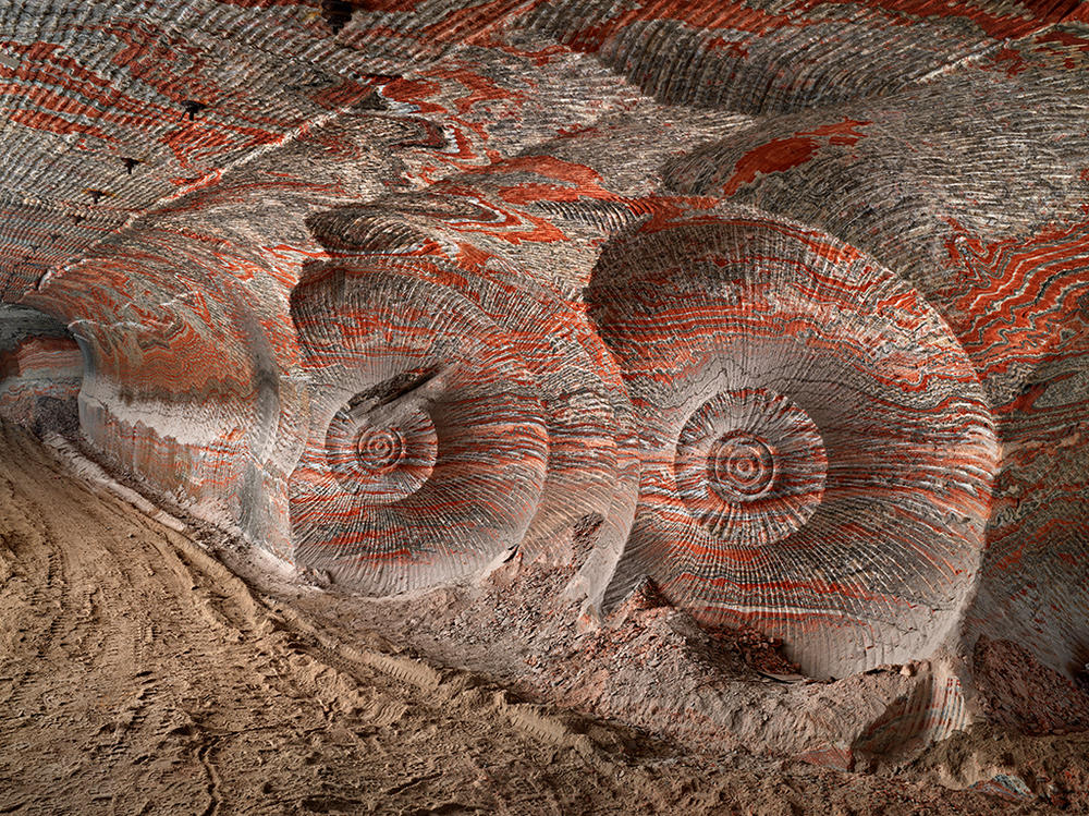 An underground potash mine in the Ural mountains of Russia. The potassium-rich salt is mined to produce fertilizer. The team says that the mine shows the impact of modernized agricultural practices that help feed Earth's 7.5 billion people. The spiraled pattern seen here is caused by the machines used to extract the salts.