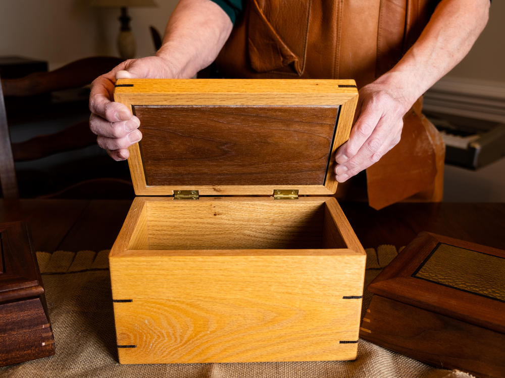 Noffsinger opens a wooden box that he made using a SawStop table saw, which uses technology to prevent serious injury.