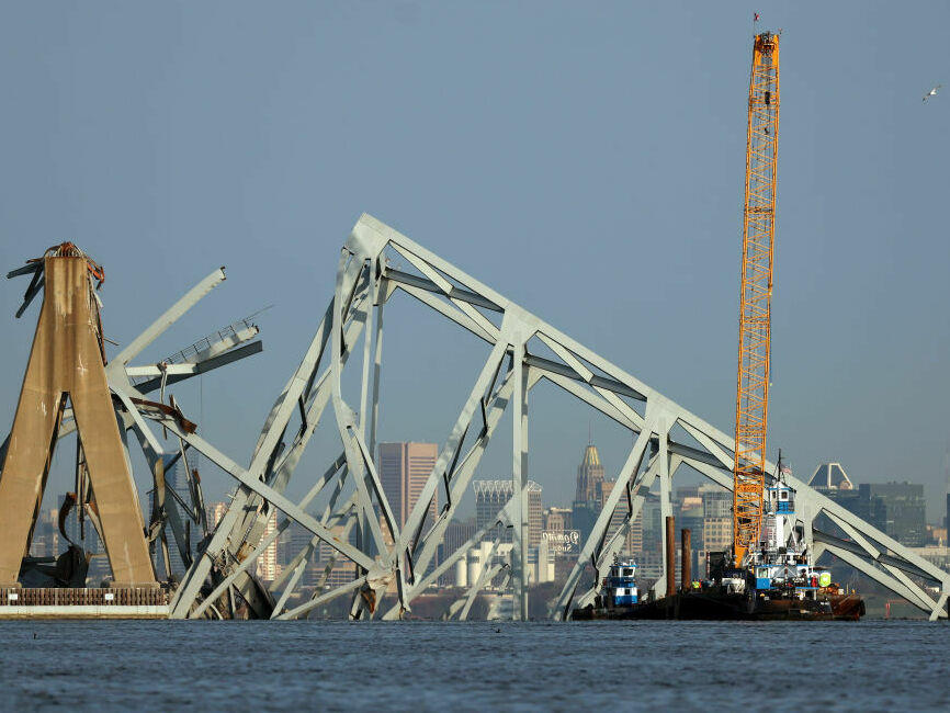 A crane is used to clear debris from the Francis Scott Key Bridge in Baltimore on Friday.