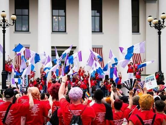 Advocates outside Florida's historic Capitol wave drag pride flags during the Drag Queens March in 2023.
