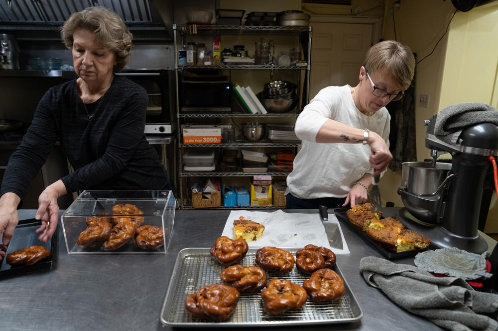 Powell and her mother, Naysa Withem, load a display case with baked goods.