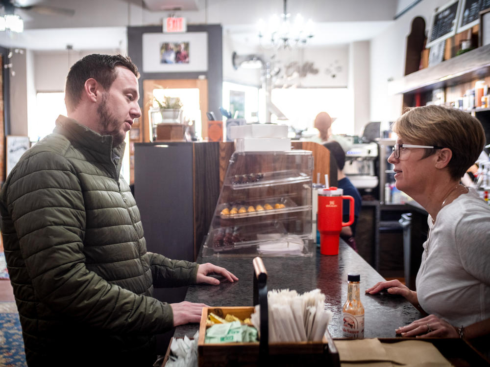 Powell says hello to her brother, Benjamin Withem, at her coffee shop.