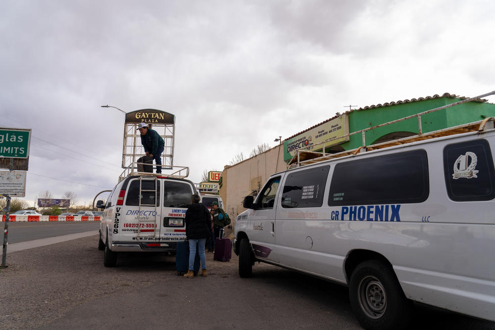 Drivers for the transportation service, Transporte Directo, pack up vans of people traveling from the U.S.-Mexico border in Douglas, Ariz., to Tucson and Phoenix.