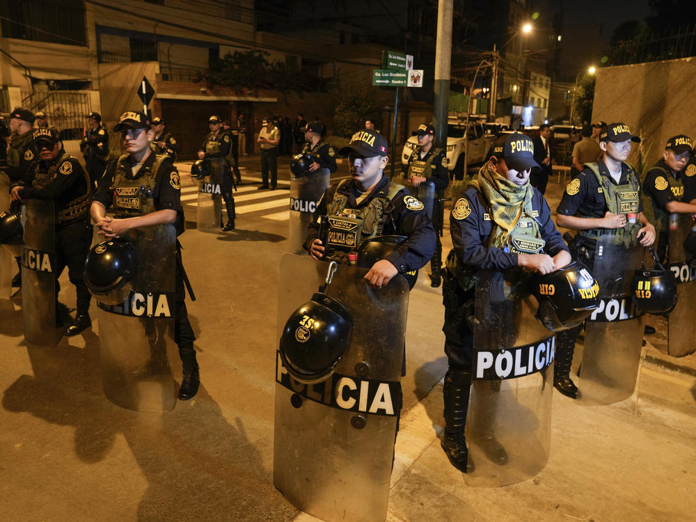 Police guard outside President Dina Boluarte's house during a raid ordered by the Attorney General's Office aimed at seizing luxury watches as part of a preliminary investigation into alleged illicit enrichment in Lima, Peru, Saturday, March 30, 2024.