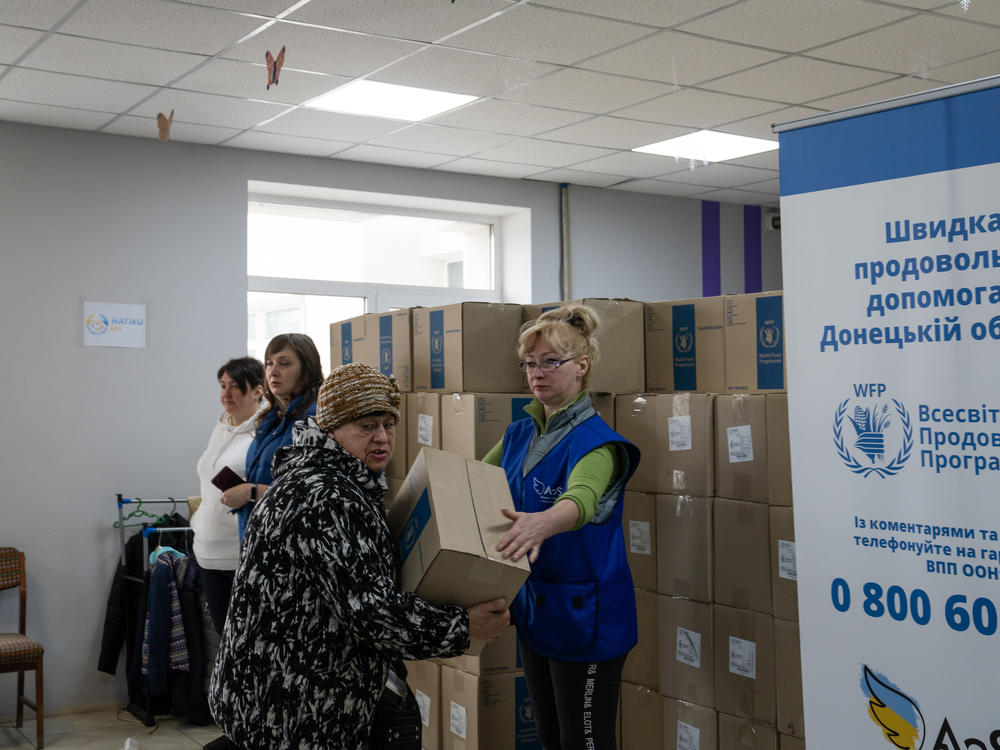 People line up for humanitarian aid at a handout location in Kostiantynivka.