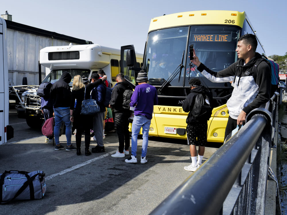 Venezuelan migrants gather at the Vineyard Haven ferry terminal in Marthas Vineyard. The group was transported to Joint Base Cape Cod in Buzzards Bay.