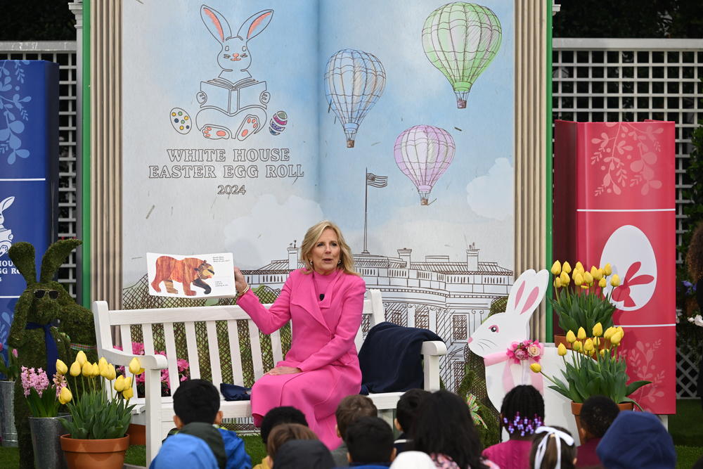 First Lady Jill Biden reads a book to children during the annual White House Easter Egg Roll.