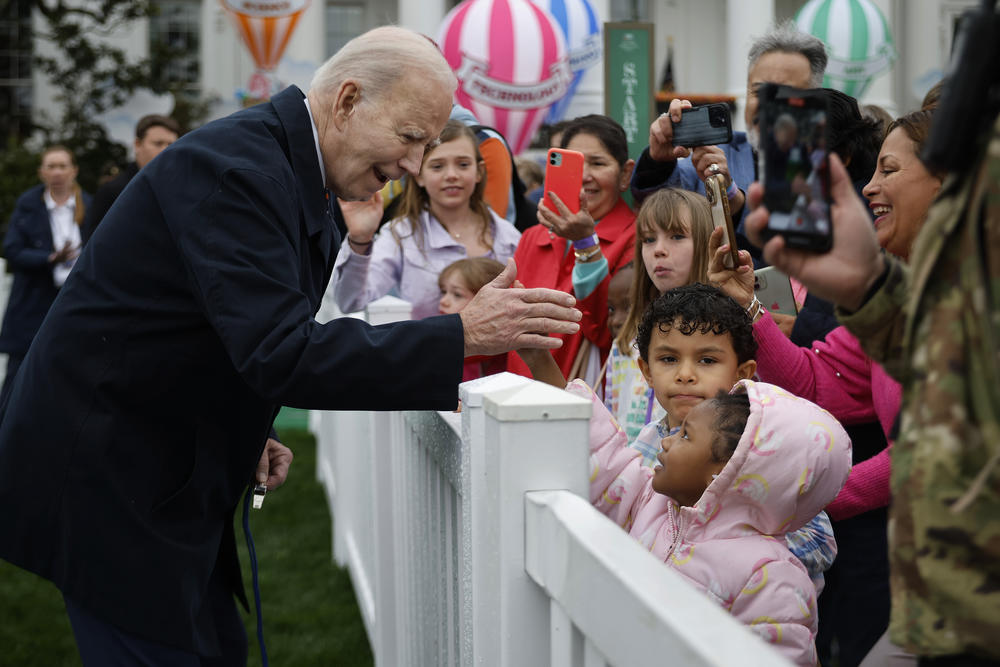 President Joe Biden greets young guests during the White House Easter Egg Roll.