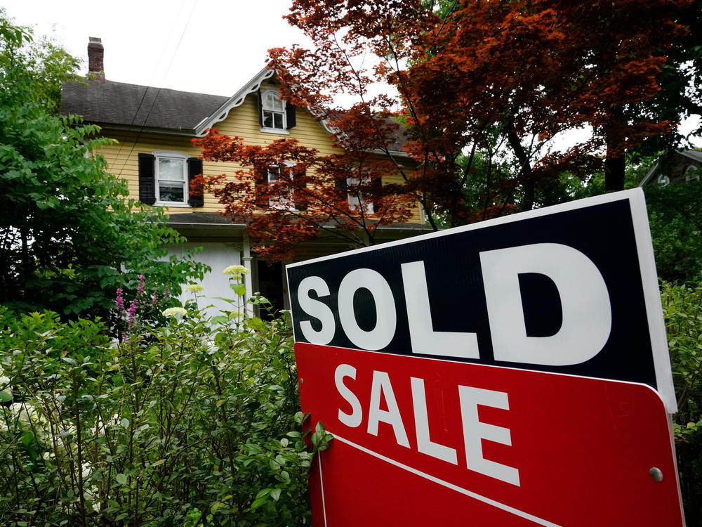 A sold sign stands outside a home in Wyndmoor, Pa., on June 22, 2022. Two recent studies suggest that prospective homeowners will have to earn more than $100,000 annually to afford a typical home in much of the U.S.