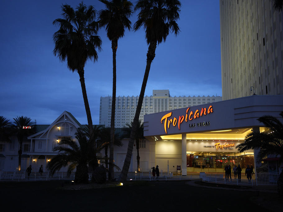People walk outside of the Tropicana hotel-casino March 28 in Las Vegas. The property closed on Tuesday.