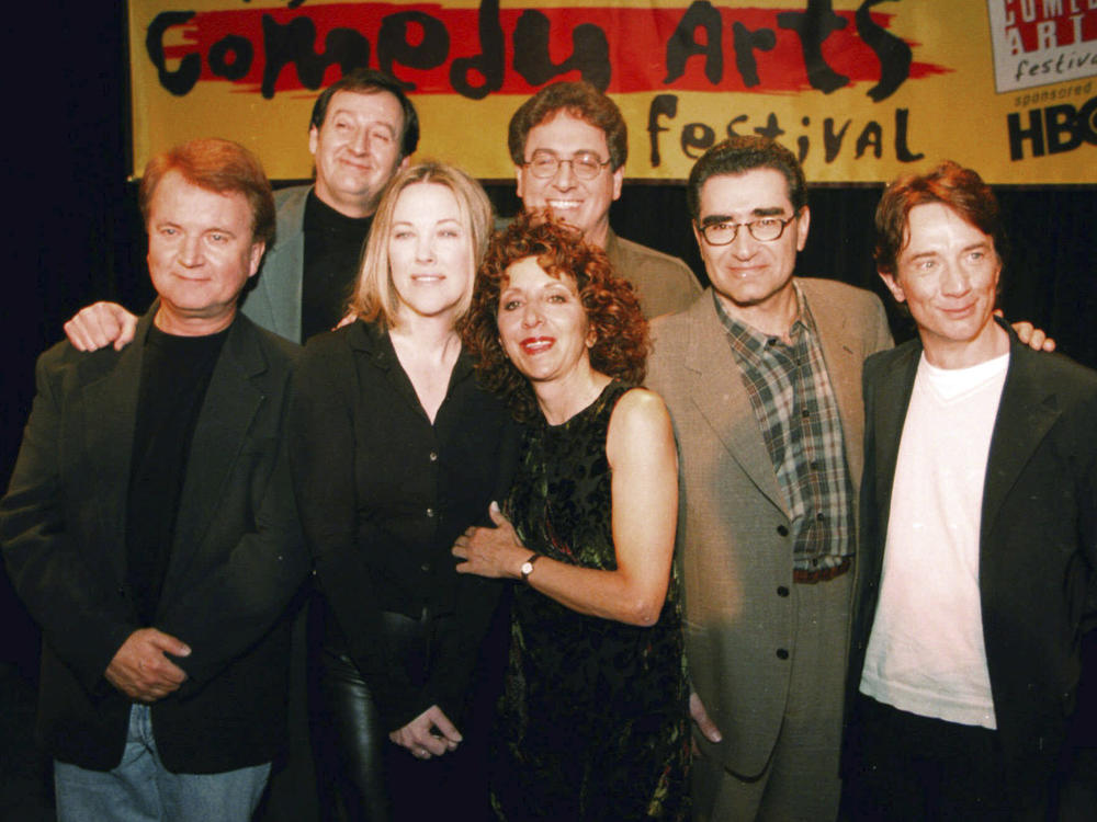 Former cast members of SCTV Dave Thomas (from left), Joe Flaherty, Catherine O'Hara, Andrea Martin, foreground, Harold Ramis, Eugene Levy and Martin Short, pose at the U.S. Comedy Arts Festival on March 6, 1999, in Aspen, Colo. Flaherty, a founding member of the Canadian sketch series 