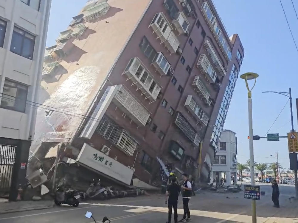 In this image taken from a video footage run by TVBS, a partially collapsed building is seen in Hualien, eastern Taiwan on Wednesday. A powerful earthquake rocked the entire island of Taiwan early Wednesday, collapsing buildings in a southern city and creating a tsunami that washed ashore on southern Japanese islands.