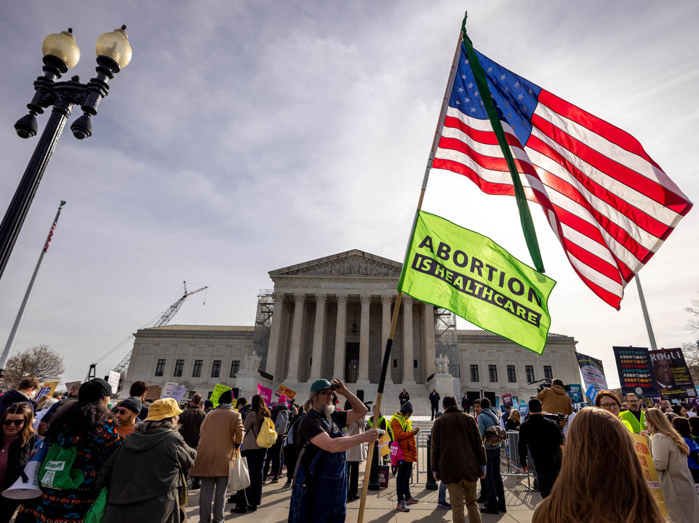 Demonstrators protest and argue outside the U.S. Supreme Court.