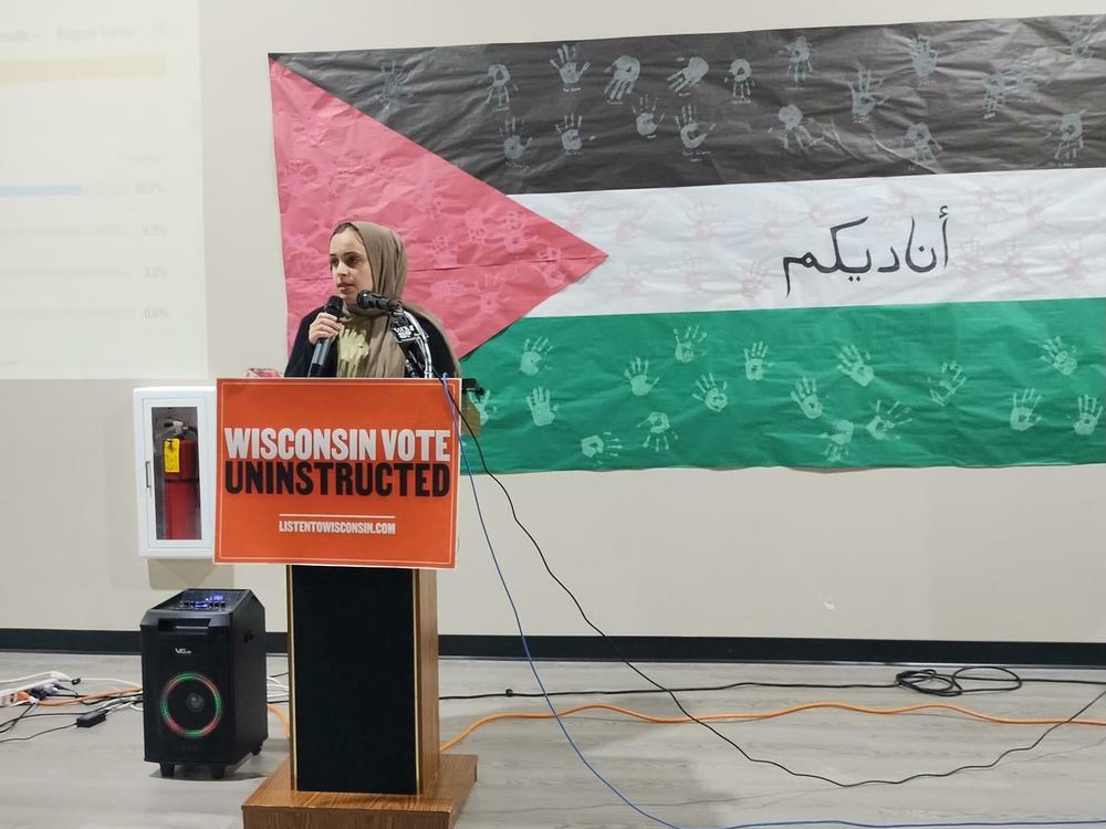 Halah Ahmad of Listen to Wisconsin speaks to supporters of the 
