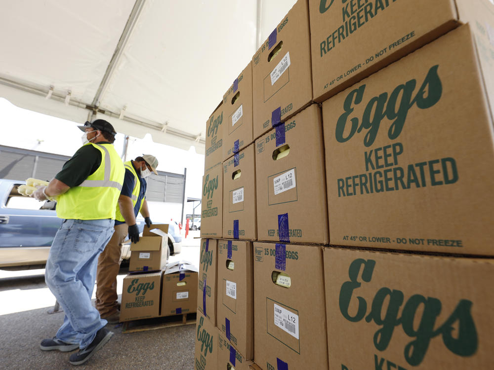 Cases of eggs from Cal-Maine Foods, Inc., await to be handed out by the Mississippi Department of Agriculture and Commerce employees at the Mississippi State Fairgrounds in Jackson, Miss., on Aug. 7, 2020.