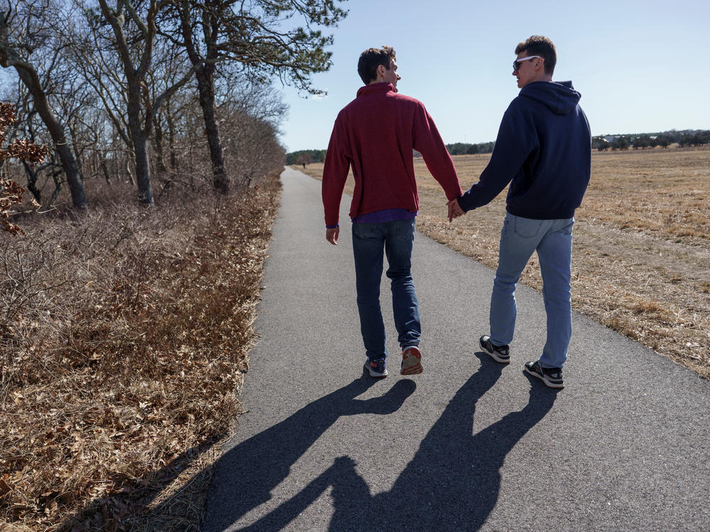 Twin brothers Sam and John take a walk outside their family home on Martha's Vineyard.