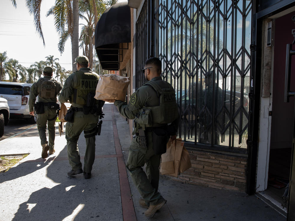 California Department of Cannabis Control detectives, with support of Long Beach law enforcement serve a search warrant and remove cannabis products at an unlicensed dispensary in Long Beach, Calif., on March 5, 2024.