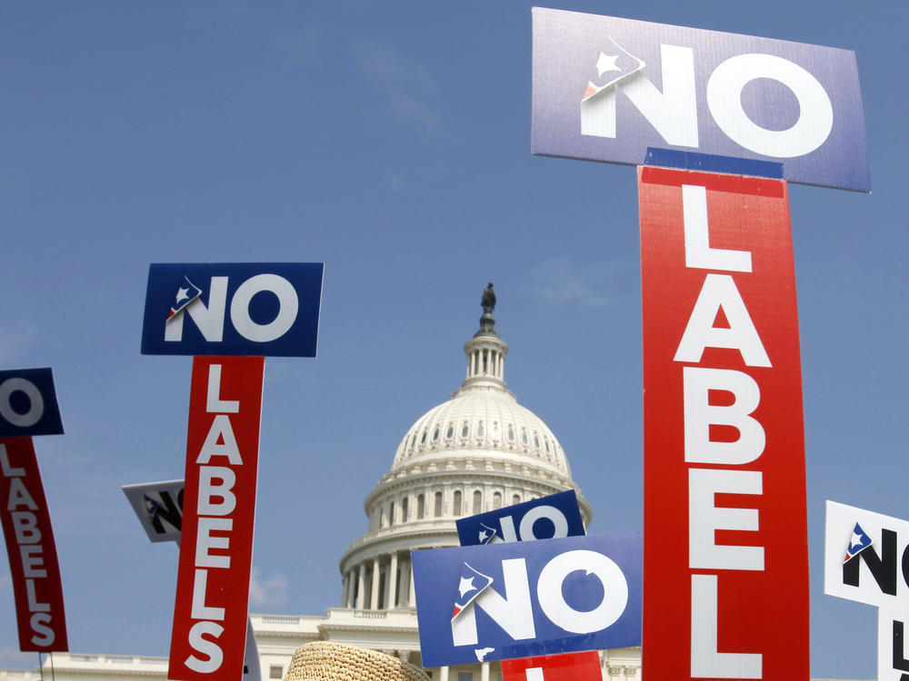 People with the group No Labels hold signs during a rally on Capitol Hill in 2013. No Labels says it won't field a presidential candidate in November after strategists for the bipartisan organization were unable to attract a candidate willing to seize on the widespread dissatisfaction with President Joe Biden and Donald Trump.