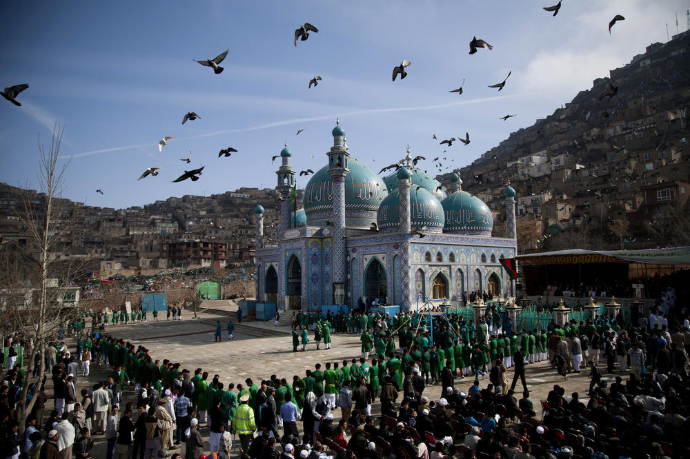 Hundreds of Afghans wait to see the holy flag at the Kart-e Sakhi mosque in Kabul, Afghanistan, March 21, 2013.
