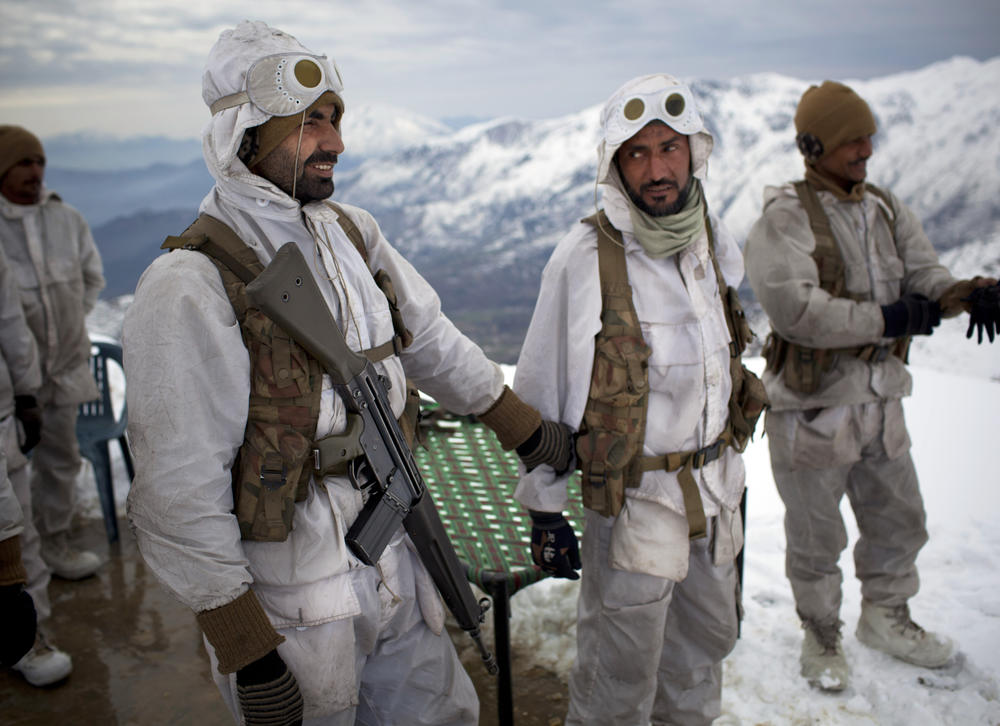 Pakistani Army soldiers with the 20th Lancers Armored Regiment gather before a patrol atop the 8,000-foot mountain near their outpost along the Pakistan-Afghan border, Feb. 20, 2012.