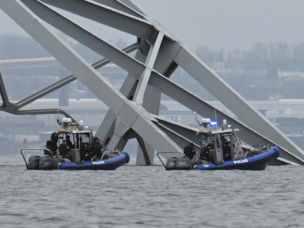 Police recovery crews work near the collapsed Francis Scott Key Bridge after it was struck by the container ship Dali in Baltimore, Maryland