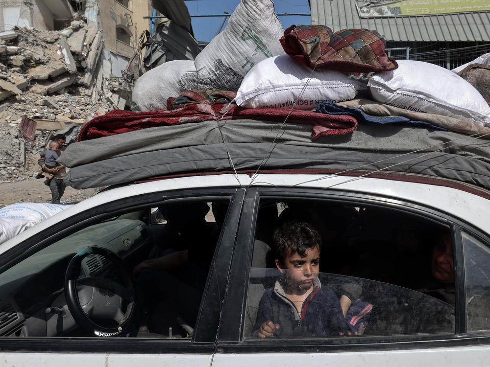 A young boy looks out from the window of a car as members of a Palestinian family leave Rafah in the southern Gaza Strip with personal belongings.