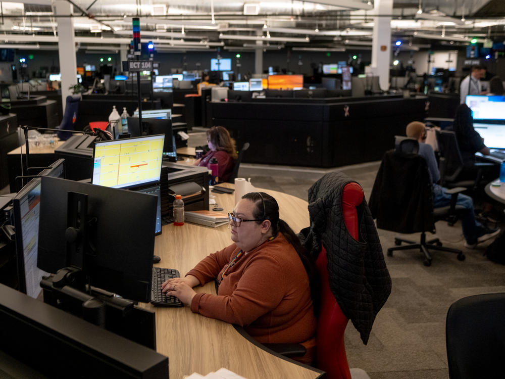 Silvia Morales, a bilingual emergency communications technician, works between calls at Denver 911.