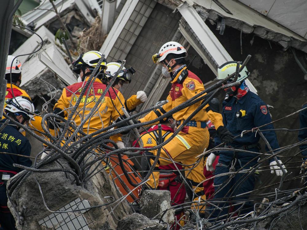 Rescue workers are shown looking for possible victims within the remains of an apartment that collapsed in the magnitude 6.4 earthquake, in the southern Taiwanese city of Tainan on Feb. 10, 2016.