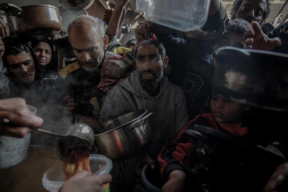 Palestinians gather at a soup kitchen in northern Gaza in order to receive food, in Beit Lahia, Feb. 26.