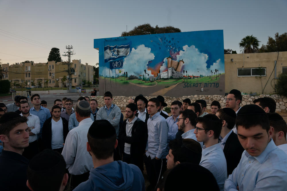 A tour group from a religious seminary visits the site of the former police station in Sderot, Israel, on March 20, where Hamas militants attacked and killed around 30 police officers civilians on Oct. 7.