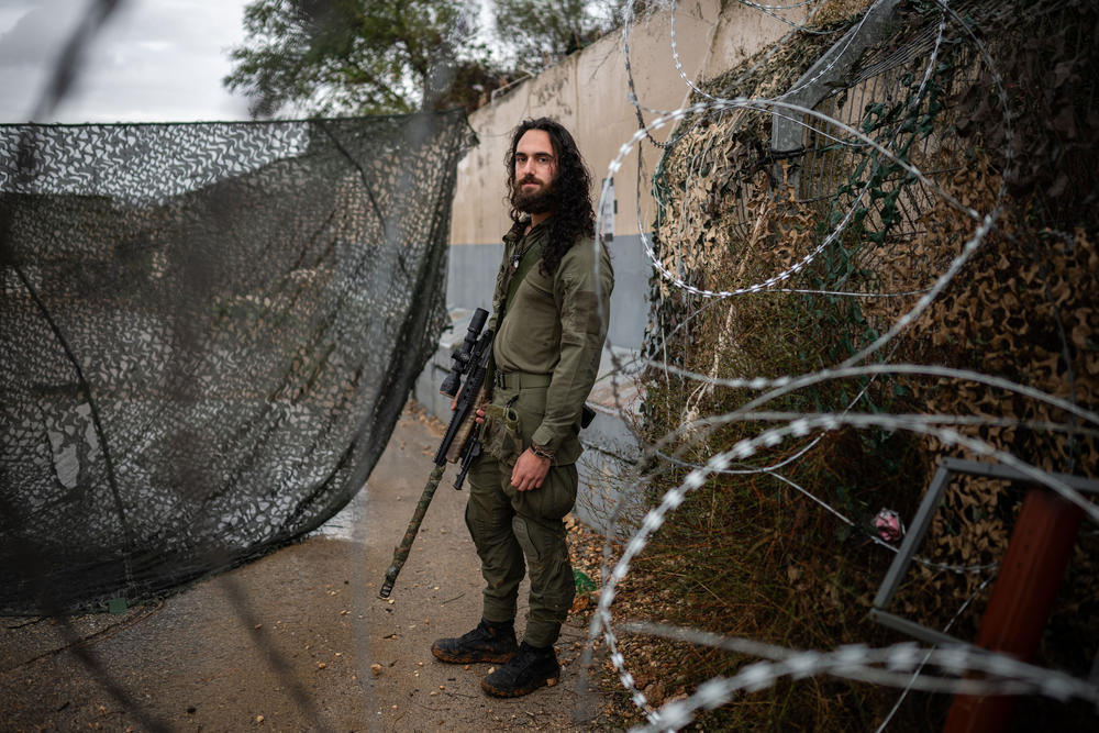 Amit Michelson, an Israeli military reservist, stands at a military base near the border with Lebanon in northern Israel on Nov. 28, 2023.