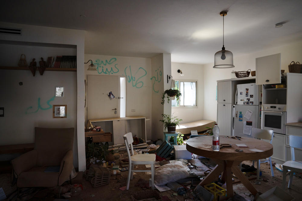 Damage is seen in a home in Kibbutz Be'eri, a community attacked by Hamas militants near the Israeli-Gaza border on Oct. 7, 2023. Graffiti left by the attackers can be seen on the walls of the home.