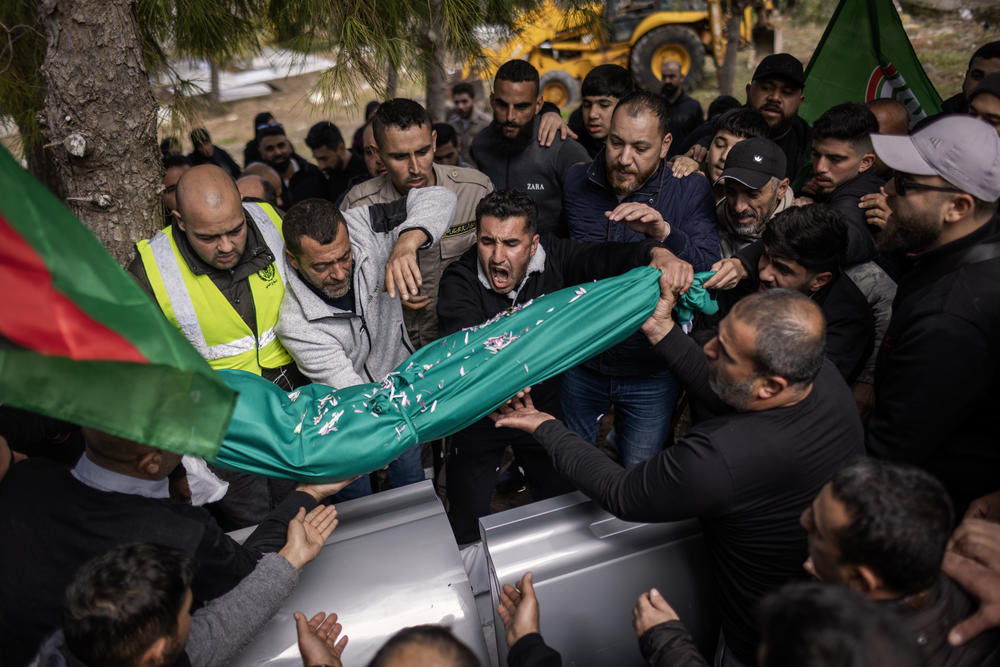 Relatives of five-year-old Amal Hassan Al Durr lay her body to rest at a cemetery on Feb. 22. She was killed during an Israeli attack in Majdal Zoun, Lebanon.