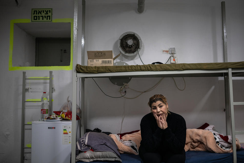 Sisilya el-Ousi sits in her apartment building's bomb shelter, where she spends most of her time, in Kiryat Shmona, Israel, on Jan. 7.