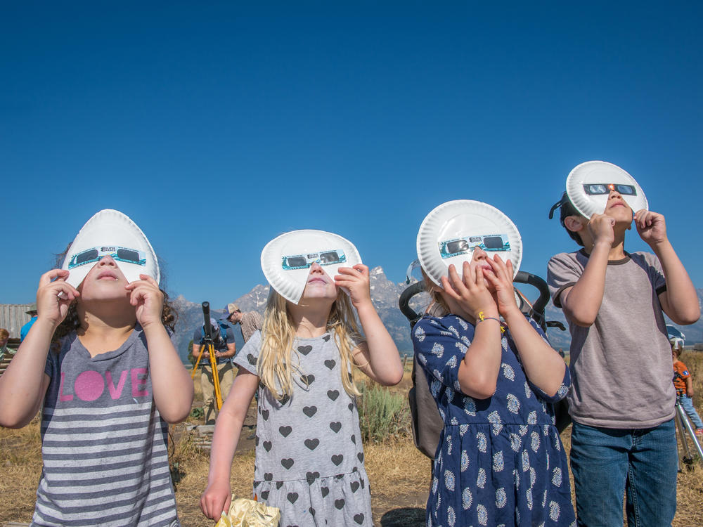 A group of children don eclipse glasses to watch the 2017 solar eclipse at Grand Tetons National Park in Wyoming.
