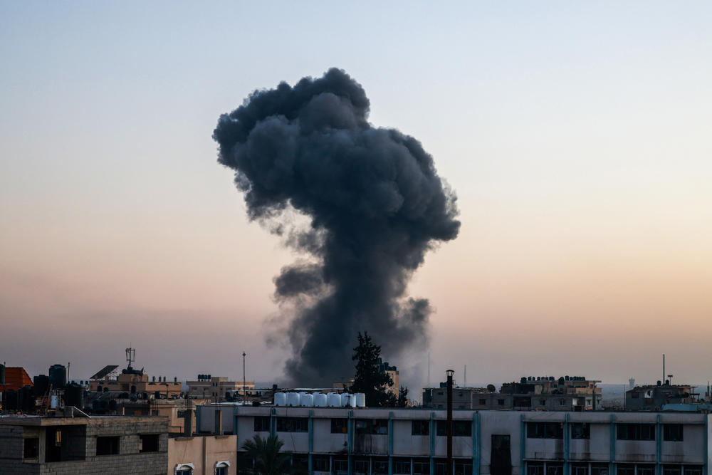 A billow of smoke rises over buildings after an Israeli strike in Rafah, southern Gaza Strip, on Thursday, amid the ongoing conflict between Israel and the Palestinian militant group Hamas.