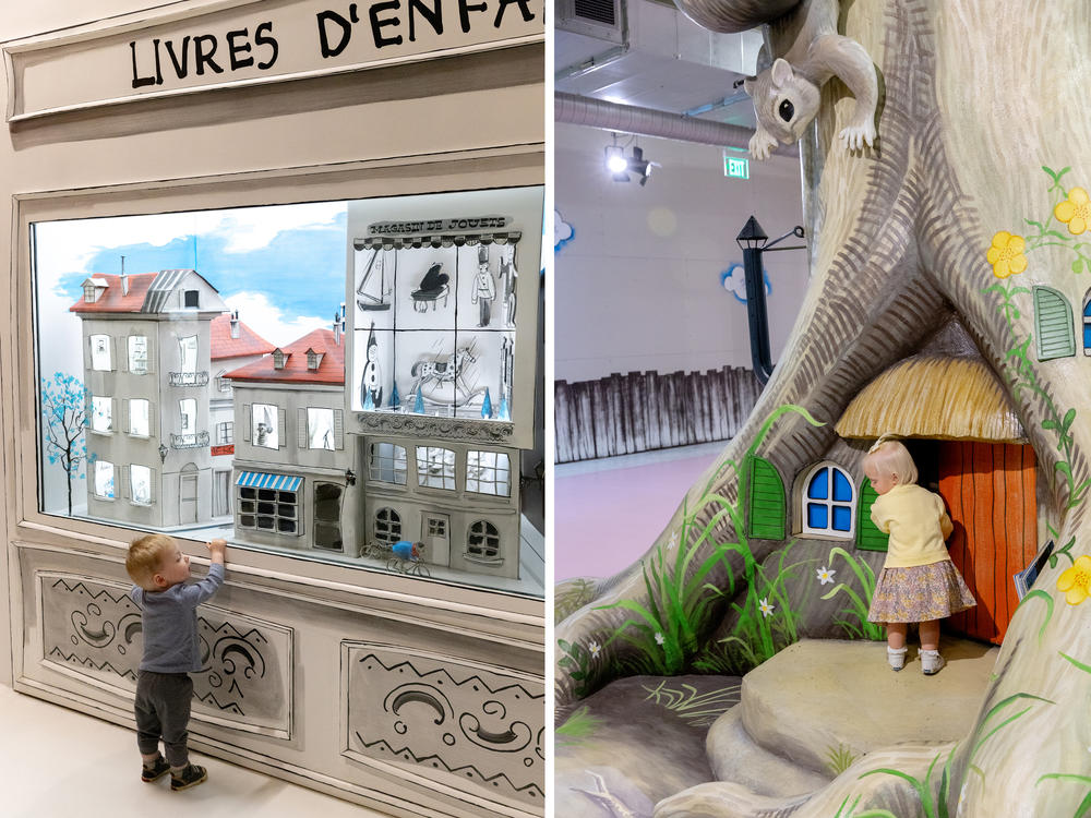 <strong>Left:</strong> Cal Kreiling, 16 months, watches a mouse on a bike from the book <em>Anatole</em>. <strong>Right:</strong> Parker Crawford, 18 months, knocks on the door to a tree inside the museum.