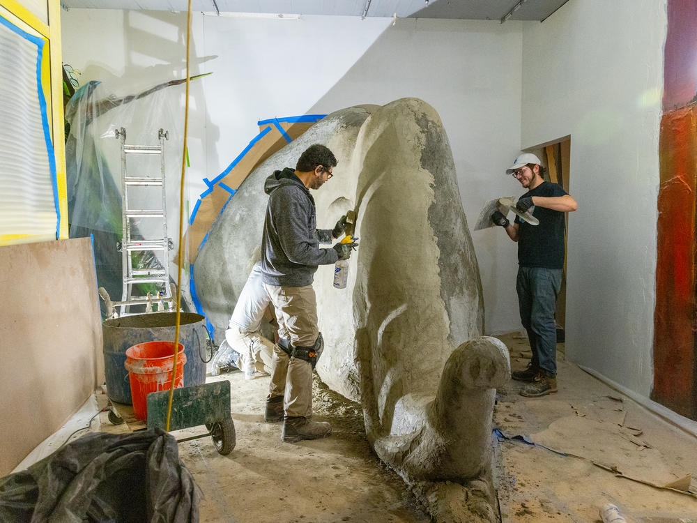A team of fabricators work on the exhibit inspired by the book <em>Everybody Needs a Rock</em> by Byrd Baylor in January, before the museum opened to the public.