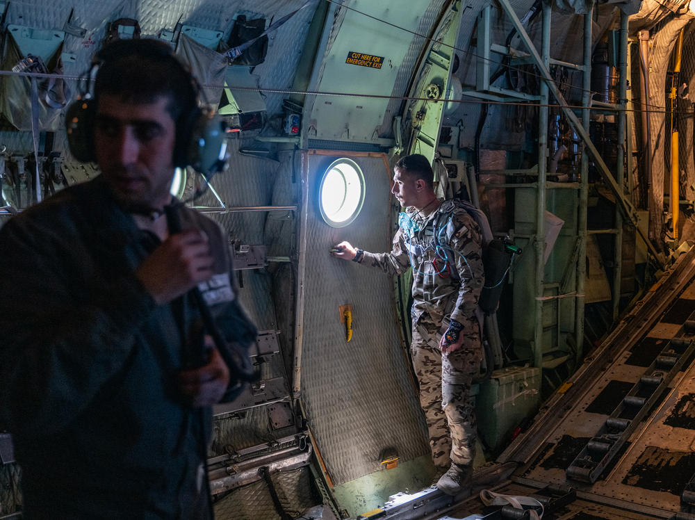 Jordanian air force personnel stand inside a C-130 aircraft after airdropping pallets of aid over Gaza in March.