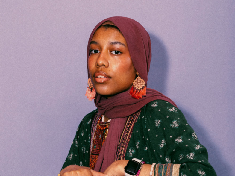 Asiyah Herrera poses in the office of 826 Boston, a nonprofit writing organization where she works as a teaching artist.