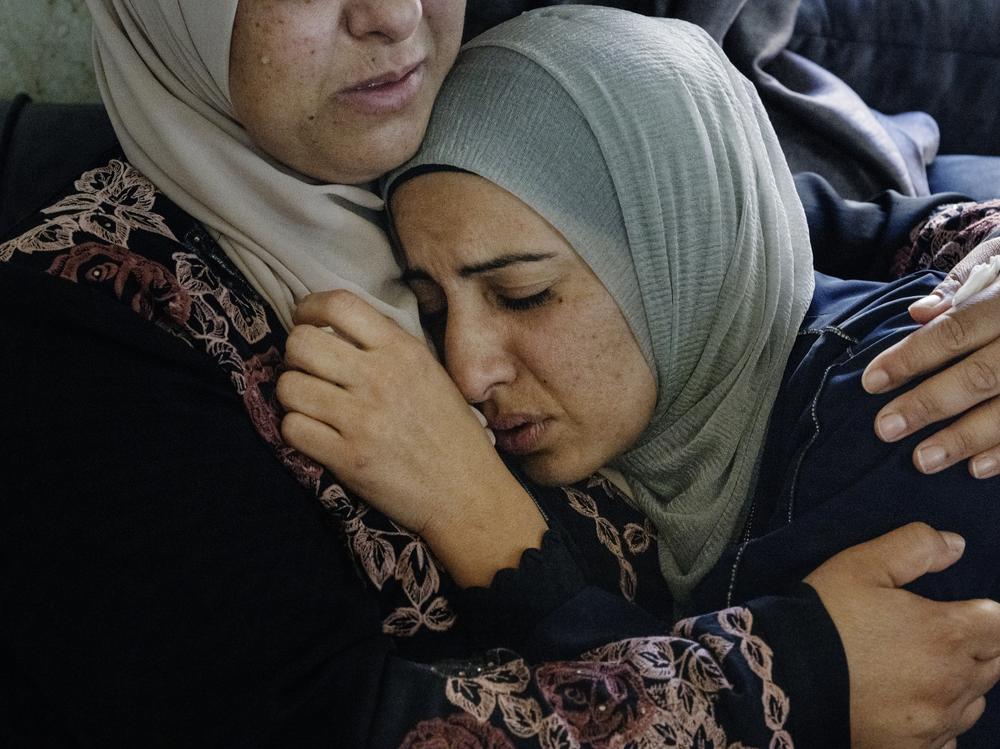 Sisters, wives, mothers and cousins of residents in the village of Qusra in the West Bank gather to mourn their Palestinian loved ones killed by armed Israeli settlers just days after the Oct. 7 Hamas-led attack.